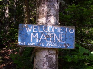 The sign welcoming thru-hikers to Maine, which reads "WELCOME TO MAINE: THE WAY LIFE SHOULD BE"